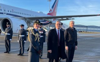 Prime Minister Keir Starmer and his Norwegian counterpart look up at the sky as Typhoons fly overhead to welcome them both to RAF Lossiemouth in Scotland to meet serving personnel