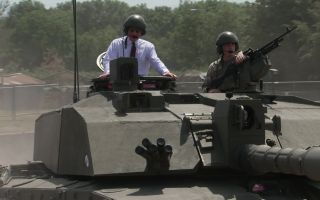 King Charles takes a ride in a Challenger 2 as he visits the Royal Tank Regiment for the first time as its Colonel-in-Chief (Picture: BFBS)