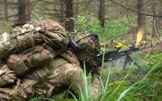 A soldier from 3 Scots fires a General Purpose Machine Gun during Exercise Forest Guardian