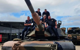 HMS Tamar crew pose on the tanks turret