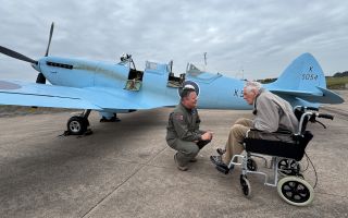 Former Spitfire pilot Douglas Seale chats with a pilot by a replica of the original protoype