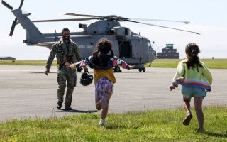 Children run to their father who has just returned from an air defence mission in Cyprus (Picture: MOD)