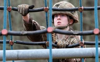 An Army recruit tackles an obstacle course