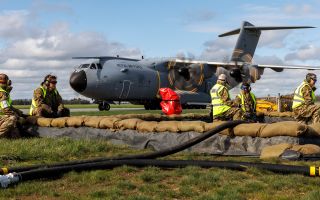 Personnel from 1 Expeditionary Logistics Squadron wait by the runway to offload, test and reload fuel from an A400M as part of Exercise Agile Warrior, which tests the RAF's Transition to Conflict capabilities
