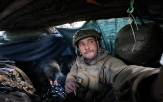 Ukrainian soldier in a trench smoking