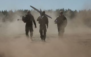 Three soldiers walking in dusty conditions on Ex Aurora CREDIT NATO