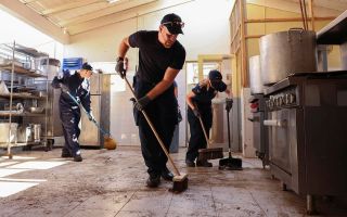HMS Trent personnel help clean up Falmouth Hospital kitchen after Hurricane Melissa