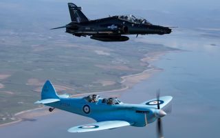 The Spitfire TR9 flies alongside a Hawk T2 as it makes its way from Prestwick to RAF Valley