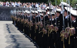 The newly-commissioned officers hold their ceremonial swords on the parade ground (Picture: Royal Navy)