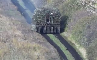 The vehicles are heavily protected by an anti-drone lattice of rods, which give them a dandelion appearance (Picture: YouTube Code 9.2)