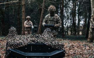 Soldiers use the Gereon RCS uncrewed ground vehicles in a forest CRED ARX Robotics