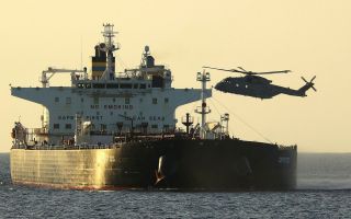 The initial boarding party fast-roped onto the crude oil tanker Smyrtos from two Chonooks, with police officers from the National Crime Agency being dropped off by this Merlin (Picture: MOD)