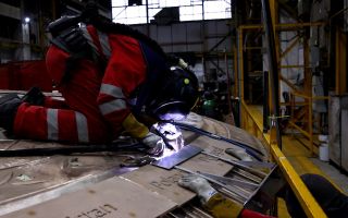 A welder works on the UK-made Unity Shield memorial to those who served in the coalition in the First Gulf War