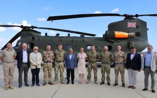 King Abdullah poses with a Chinook used for firefighting duties