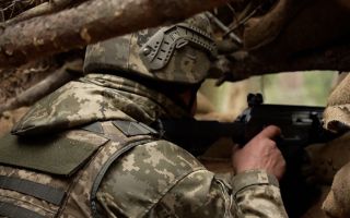A Ukrainian soldier keeps a lookout for the enemy while being trained on Operation Interflex