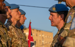 Coldstream Guards awarded medals at a parade inside the Green Line buffer zone