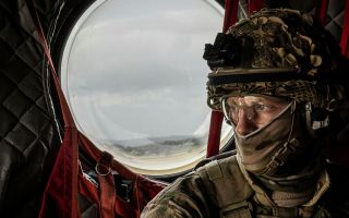 A gunner from the RAF Regiment thinks about the action to come as he flies low over the north of England on board a 27 Squadron Chinook during Exercise Cobra Warrior (Picture: MOD)