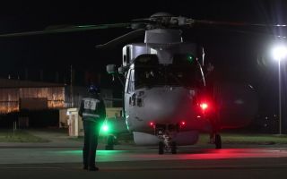The pilot gives a thumbs up as he prepares to start the engines of the Merlin Mk2 Crowsnest