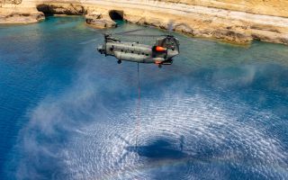 A firefighting Chinook from 1310 Flight fills its Bambi bucket with water during a training sortie ahead of the wildfire season in Cyprus (Picture: MOD)