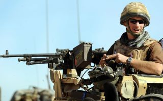 Prince Harry sitting in his position on a Spartan armoured vehicle in Helmand Province, Afghanistan (Picture: PA Images)