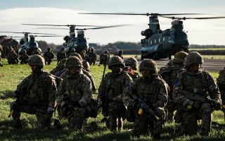 Troops from 2nd Battalion the Parachute Regiment wait to board RAF Chinooks during Exercise Pinion Titan