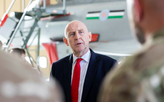 Mr Healey pictured visiting British troops in Qatar in his previous role as defence secretary (Picture: MOD)