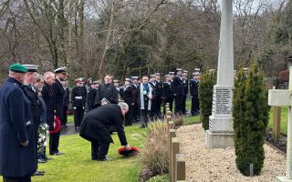 A wreath is laid at the base of the memorial for the victims of the K13 disaster