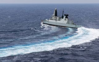 MS Dragon is snapped from a Wildcat Helicopter as the ship conducts high-speed manoeuvres as she continues to carry out air defence operations in the Eastern Mediterranean