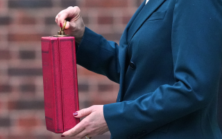 Chancellor Rachel Reeves holds the Red Box containing the Budget document outside Downing Street before delivering her speech in the House of Commons