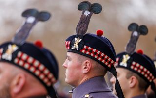 Members of Balaklava Company, 5th Battalion The Royal Regiment of Scotland, show off the blackcock feather plumes on their Glengarry bonnets at Wellington Barracks as they prepare to serve as the next King's Guard