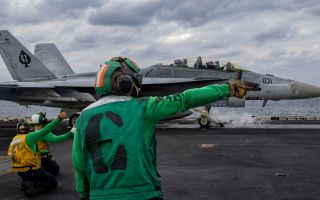 An F/A-18F Super Hornet attached to Strike Fighter Squadron (VFA) 41 prepares to launch from the flight deck of USS Abraham Lincoln in the Arabian Sea