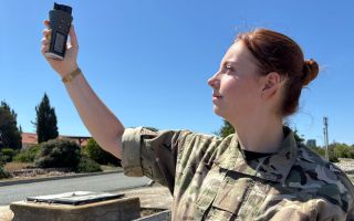 Senior Operational Meteorologist Flying Officer Robyn Waldie checks the weather conditions with an anemometer (Picture: BFBS)