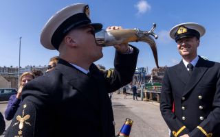 A sailor enjoys a measure of Pussers Rum - something that's going to be more of a rarity in future