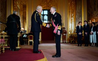Admiral Sir Tony Radakin shakes hands with the King during his investiture ceremony at Windsor Castle