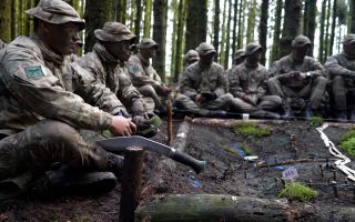 Gurkha recruits at ITC Catterick build a model of the ground during a fieldcraft exercise