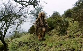 A trainee British Army sniper uses camouflage and concealment to keep the enemy - or in this case the Directing Staff - unaware of his presence