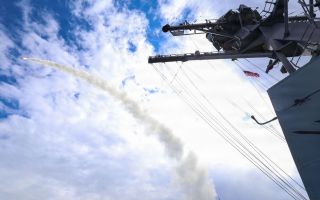 Arleigh Burke-class guided-missile destroyer USS Thomas Hudner (DDG 116) fires a Tomahawk land attack missile