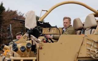Then-Defence Secretary Grant Shapps gets behind the wheel of a Jackal