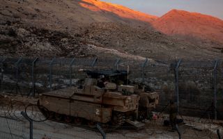 Israeli troops are seen near the buffer zone fence on the eastern side of the Golan Heights, on 101224 CREDIT Alamy