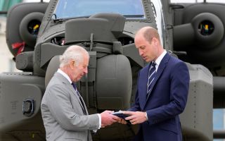 King Charles III officially hands over the role of Colonel-in-Chief of the Army Air Corps to the Prince of Wales, in front of an Apache helicopter 130524 