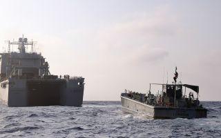 RFA cardigan bay with a us water craft sailing to the gaza pier