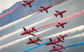 Red Arrows spraying their customary red, white and blue smoke from their Hawk T1 jets