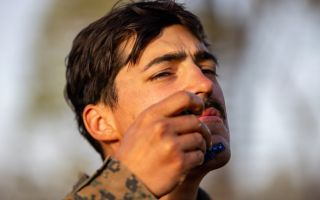 A US Marine Corps sergeant keeps on the corps' good side as he shaves during an exercise (Picture: US Department of War)