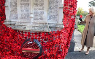 The Queen attached the final poppy to complete the cascade of 10,000 poppies draping the church tower at St Bartholomew's Church